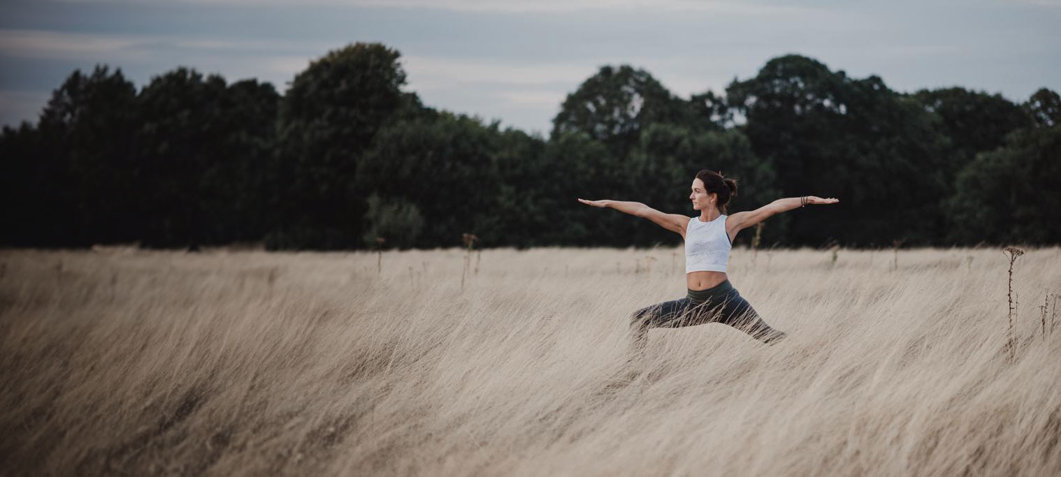 Image of Anney practicing yoga in a meadow in Twickenham
